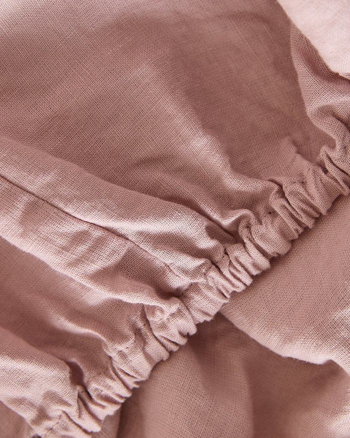 The Foxford Blush Pure Linen Fitted Sheet adds a touch of elegance and comfort to your bed. Crafted from 100% premium linen, it provides exceptional softness, breathability, and durability. The soft blush hue brings warmth and a subtle, sophisticated tone to your bedroom décor. Pre-washed for a relaxed, lived-in feel, it becomes even softer with each use. Naturally temperature-regulating and antibacterial, this fitted sheet is perfect for year-round comfort. Enhance your bedding with this luxurious and time
