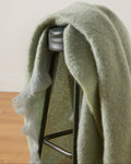 Foxford Hibernia Mohair Throw draped over a stool