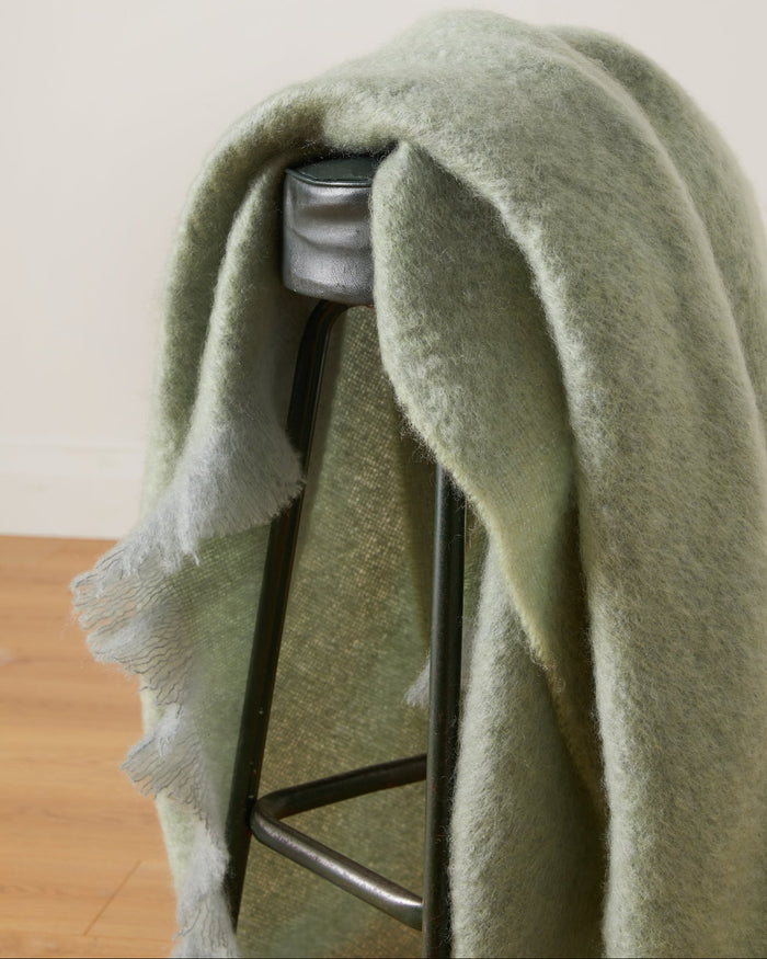 Foxford Hibernia Mohair Throw draped over a stool