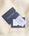 A Foxford gift card placed on a fluffy surface, showing the card's value and Foxford branding.